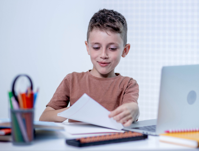 Student studying with book and laptop