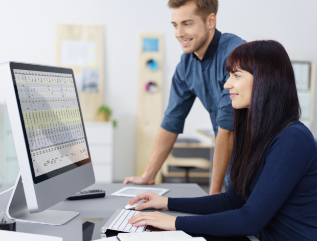 Two people collaborating at computer