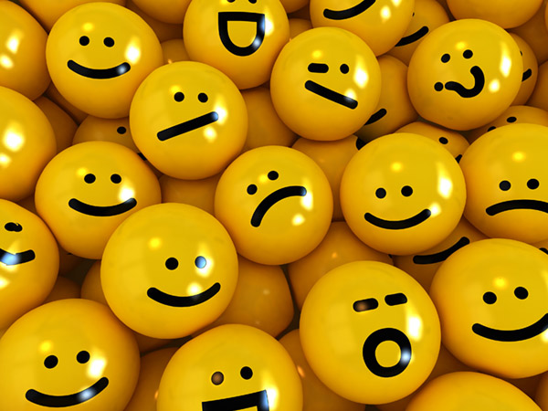 Yellow emoji balls with various facial expressions.