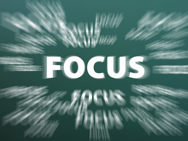 Blurred motion effect around the word 'FOCUS'.