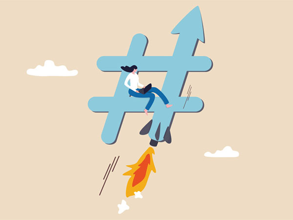 Person sitting on rocket-powered hashtag symbol flying through cloudy sky.