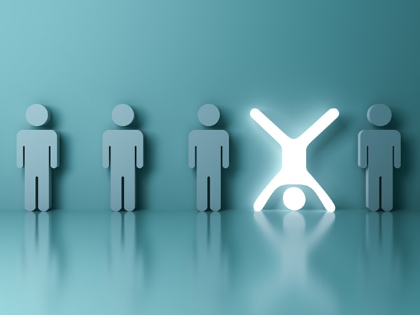 Row of gray figures with one glowing white figure standing out.
