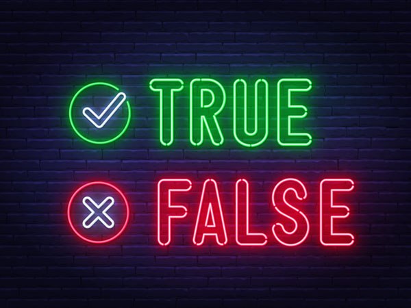 Neon signs showing "TRUE" with checkmark, "FALSE" with X.