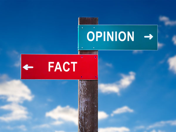 Road sign showing two directions: "FACT" in red, "OPINION" in teal.