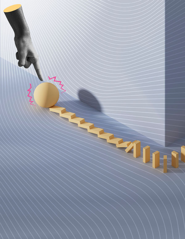 Hand pushing ball to start domino effect.