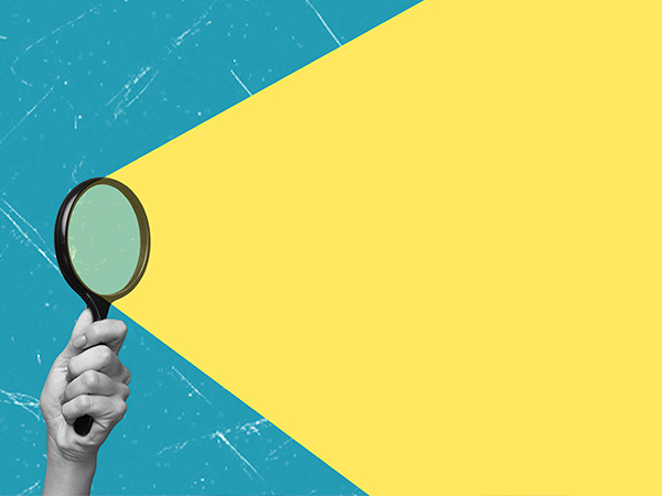 A hand holding a magnifying glass against a teal and yellow background.