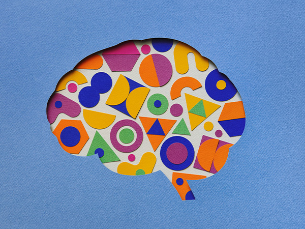 Colorful geometric shapes forming a brain outline on blue background.