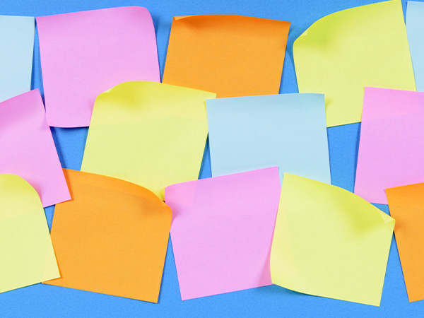 Colorful sticky notes arranged on light blue background.