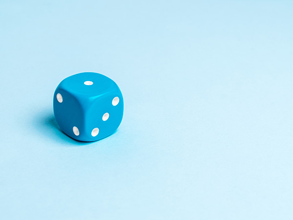 Blue dice with white dots on light blue background.