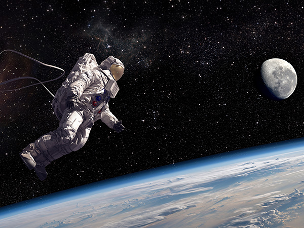 Astronaut floating in space above Earth, with moon visible nearby.