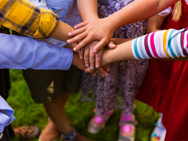 Hands stacked together, showing unity