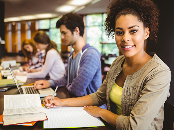 Students studying at desks in a library.